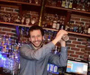 bartenders working behind the bar